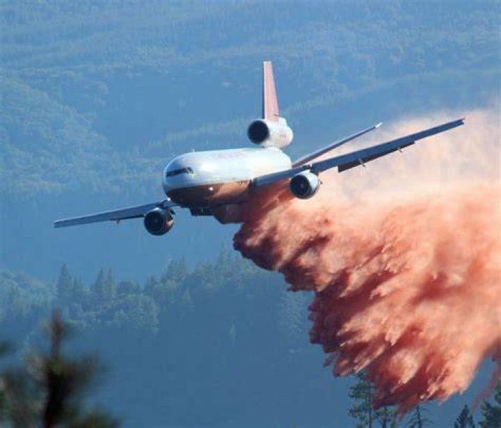 An air tanker drops fire retardant along a ridge to help contain the Rocky fire near Clearlake, California on August 2, 2015. Photo by Josh Edelson/AFP/Getty Images