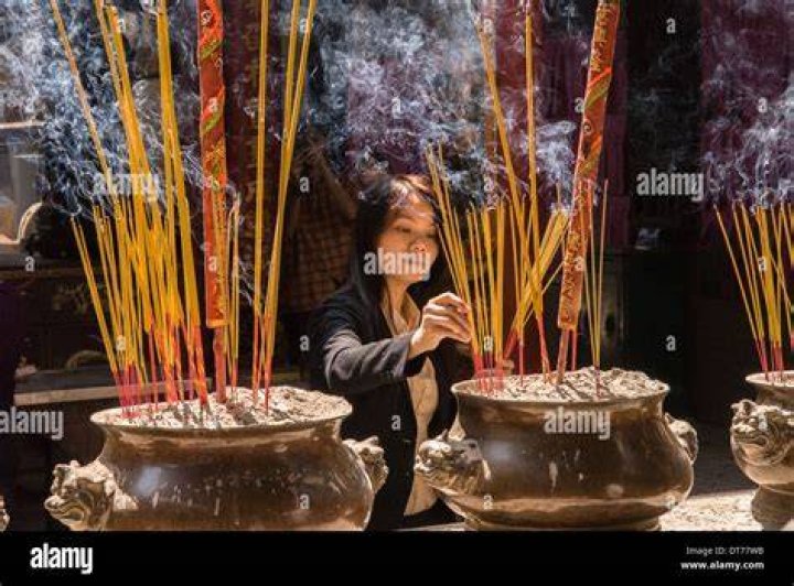 Woman lights incense
